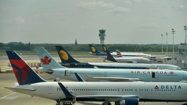 The Belgocontrol tower is seen in the background, and aeroplanes grounded on the runway of Brussels airport in Zaventem, as the whole Belgian aerial space is closed after a power cut at air traffic control organization Belgocontrol, on May 27, 2015 - Sputnik International
