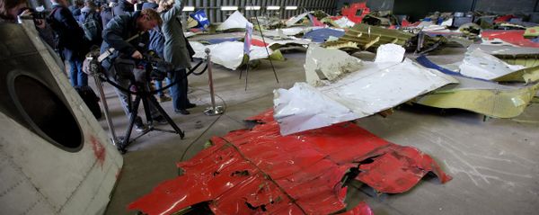 Journalists take images of parts of the wreckage of the Malaysia Airlines Flight 17 displayed in a hangar at Gilze Rijen airbase, Netherlands, Tuesday, March 3, 2015 Journalists take images of parts of the wreckage of the Malaysia Airlines Flight 17 displayed in a hangar at Gilze Rijen airbase, Netherlands, Tuesday, March 3, 2015 - Sputnik International