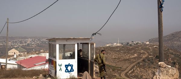 Israeli soldiers stand guard at their position at the West Bank Israeli outpost of Achiya, near the Palestinian village of Jalud Duma (background), on August 4, 2015, a week after the house of a Palestinian Dawabsha family was set on fire by suspected Jewish extremists, killing 18-month-old Ali Saad Dawabsha and critically injuring his parents and four-year-old brother Israeli soldiers stand guard at their position at the West Bank Israeli outpost of Achiya, near the Palestinian village of Jalud Duma (background), on August 4, 2015, a week after the house of a Palestinian Dawabsha family was set on fire by suspected Jewish extremists, killing 18-month-old Ali Saad Dawabsha and critically injuring his parents and four-year-old brother - Sputnik International