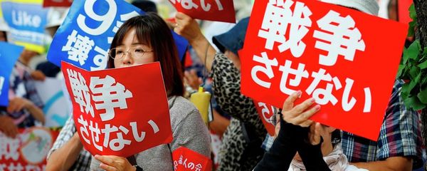 Protesters hold anti-war placards in front of the National Diet building during a rally in Tokyo Protesters hold anti-war placards in front of the National Diet building during a rally in Tokyo - Sputnik International