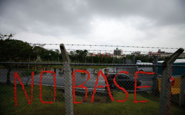 A slogan against the base is displayed on the fence enclosed U.S. Marine Corps Futenma Air Station in Ginowan on southern Japanese islands of Okinawa. File photo A slogan against the base is displayed on the fence enclosed U.S. Marine Corps Futenma Air Station in Ginowan on southern Japanese islands of Okinawa. File photo - Sputnik International