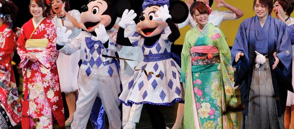 People celebrate with Disney characters on stage during a ceremony at Tokyo Disneyland. - Sputnik International