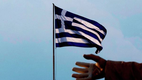 A hand of a statue is seen as the Greek flag waves in Athens, Sunday, June 28, 2015. A hand of a statue is seen as the Greek flag waves in Athens, Sunday, June 28, 2015. - Sputnik International