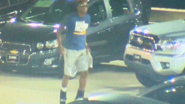 Surveillance video on the lot of a car dealership shows Christian Taylor, 19, of Arlington, Texas, jumping on vehicles August 7 before officers arrived. - Sputnik International