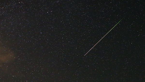 A meteor streaks across the sky during the Perseid meteor shower near Kraljevine on mountain Smetovi in the early morning August 12, 2015 - Sputnik International