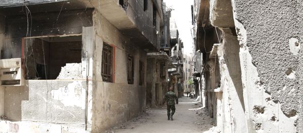 FILE PHOTO. A soldier walks down an alley through heavy damage during a government escorted visit to Yarmouk refugee camp in Damascus, Syria, Thursday, April 9, 2015 FILE PHOTO. A soldier walks down an alley through heavy damage during a government escorted visit to Yarmouk refugee camp in Damascus, Syria, Thursday, April 9, 2015 - Sputnik International