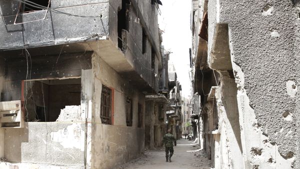 FILE PHOTO. A soldier walks down an alley through heavy damage during a government escorted visit to Yarmouk refugee camp in Damascus, Syria, Thursday, April 9, 2015 FILE PHOTO. A soldier walks down an alley through heavy damage during a government escorted visit to Yarmouk refugee camp in Damascus, Syria, Thursday, April 9, 2015 - Sputnik International