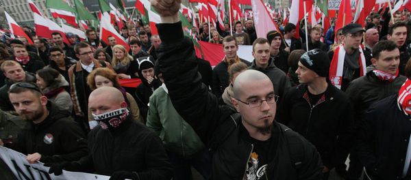Right wing protesters wave flags at the start of the Independence Day march organized by nationalist parties, in Warsaw, Poland, Tuesday, Nov. 11, 2014 Right wing protesters wave flags at the start of the Independence Day march organized by nationalist parties, in Warsaw, Poland, Tuesday, Nov. 11, 2014 - Sputnik International