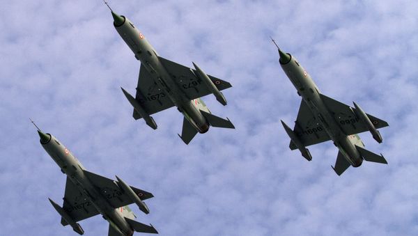  Indian Air Force (IAF) MIG 21 jet fighter aircrafts perform during a parade at an airbase in Tezpur, India, Friday, Nov. 21 2014 - Sputnik International