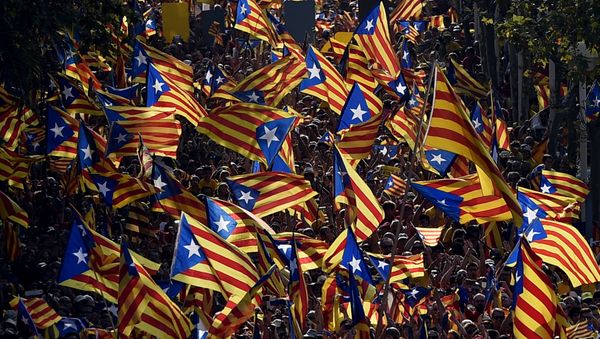 A file picture taken on September 11, 2014 shows demonstrators waving Estelada flags (Catalan independentist flags) during celebrations of the Diada (Catalonia National Day) in Barcelona. A file picture taken on September 11, 2014 shows demonstrators waving Estelada flags (Catalan independentist flags) during celebrations of the Diada (Catalonia National Day) in Barcelona. - Sputnik International