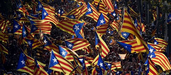 A file picture taken on September 11, 2014 shows demonstrators waving Estelada flags (Catalan independentist flags) during celebrations of the Diada (Catalonia National Day) in Barcelona. A file picture taken on September 11, 2014 shows demonstrators waving Estelada flags (Catalan independentist flags) during celebrations of the Diada (Catalonia National Day) in Barcelona. - Sputnik International
