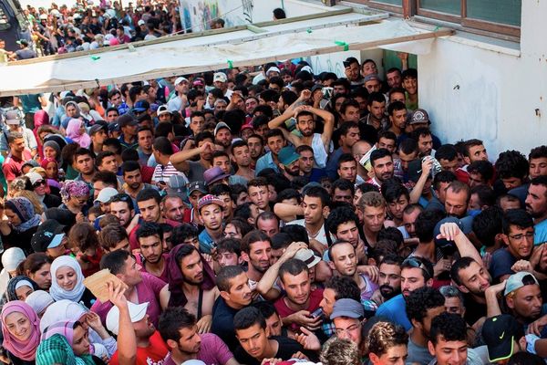 Syrian migrants and refugees gather at a makeshift migrant detention center at Kos' abandoned football stadium after crossing from Turkey, at the southeastern island of Kos, Greece, Wednesday, Aug. 12, 2015. Syrian migrants and refugees gather at a makeshift migrant detention center at Kos' abandoned football stadium after crossing from Turkey, at the southeastern island of Kos, Greece, Wednesday, Aug. 12, 2015. - Sputnik International