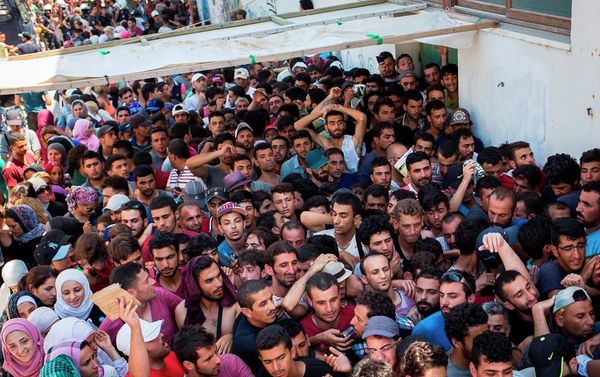 Syrian migrants and refugees gather at a makeshift migrant detention center at Kos' abandoned football stadium after crossing from Turkey, at the southeastern island of Kos, Greece, Wednesday, Aug. 12, 2015. Syrian migrants and refugees gather at a makeshift migrant detention center at Kos' abandoned football stadium after crossing from Turkey, at the southeastern island of Kos, Greece, Wednesday, Aug. 12, 2015. - Sputnik International