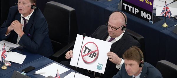 Members of the European Parliament take part in a voting session as they hold signs against the Transatlantic Trade and Investment Partnership (TTIP), on June 10, 2015, in the European Parliament in Strasbourg, eastern France Members of the European Parliament take part in a voting session as they hold signs against the Transatlantic Trade and Investment Partnership (TTIP), on June 10, 2015, in the European Parliament in Strasbourg, eastern France - Sputnik International