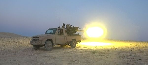This picture released on July 12, 2015 by the Rased News Network, a Facebook page affiliated with Islamic State militants, shows an Islamic State militant fires a heavy weapon during a battle against Syrian government forces, in Homs province, Syria This picture released on July 12, 2015 by the Rased News Network, a Facebook page affiliated with Islamic State militants, shows an Islamic State militant fires a heavy weapon during a battle against Syrian government forces, in Homs province, Syria - Sputnik International