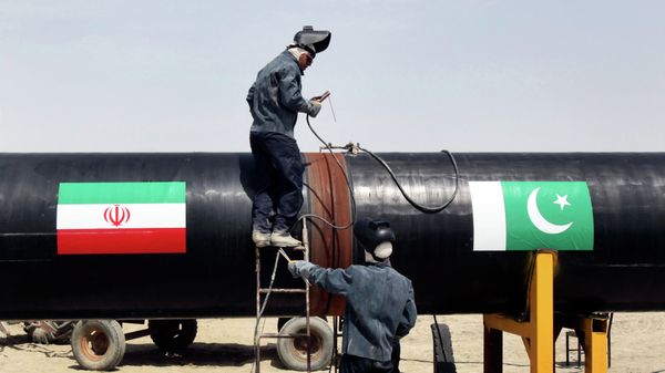 FILE - In this March 11, 2013 file photo, Iranian workers weld two gas pipes together at the start of construction on a pipeline to transfer natural gas from Iran to Pakistan, in Chabahar, southeastern Iran, near the Pakistani border - Sputnik International