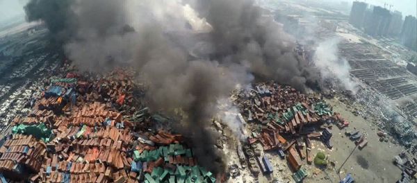 This screen grab taken from AFPTV shows an aerial image taken on August 13, 2015 of smoke rising from debris the day after a series of explosions hit a chemical warehouse in the city of Tianjin, in northern China - Sputnik International