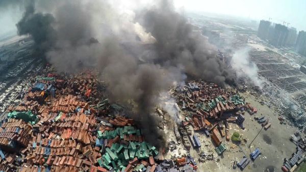 This screen grab taken from AFPTV shows an aerial image taken on August 13, 2015 of smoke rising from debris the day after a series of explosions hit a chemical warehouse in the city of Tianjin, in northern China - Sputnik International