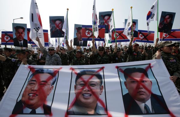Members of the Korean Disabled Veterans Association by Agent Orange in Vietnam War, shout slogans with a banner showing defaced images of North Korean leader Kim Jong Un, right, late his father Kim Jong Il, center, and Kim Il Sung, the late founder of North Korea, during a rally denouncing North Korea. Members of the Korean Disabled Veterans Association by Agent Orange in Vietnam War, shout slogans with a banner showing defaced images of North Korean leader Kim Jong Un, right, late his father Kim Jong Il, center, and Kim Il Sung, the late founder of North Korea, during a rally denouncing North Korea. - Sputnik International