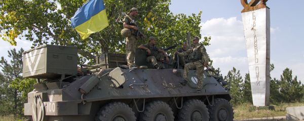 Ukrainian servicemen stand on an armoured personal carrier (APC) with an Ukrainian flag, before leaving for Ukrainian forces' positions in Staroignativka village, Donetsk region on August 12, 2015 - Sputnik International