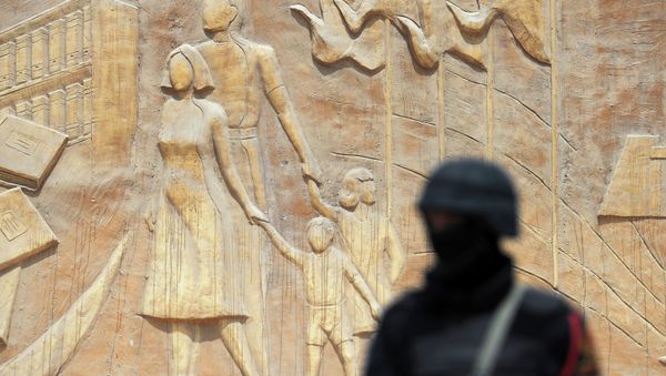 A member of the Egyptian security stands guard outside the police academy during the trial of former Islamist president Mohamed Morsi, in the capital, Cairo - Sputnik International