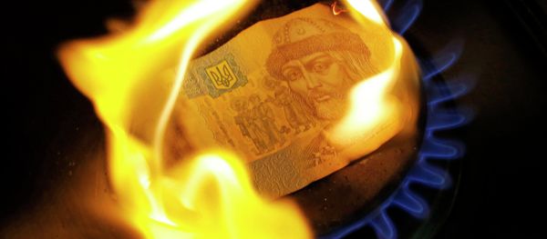 A burning one hryvnia bill on a gas burner A burning one hryvnia bill on a gas burner - Sputnik International