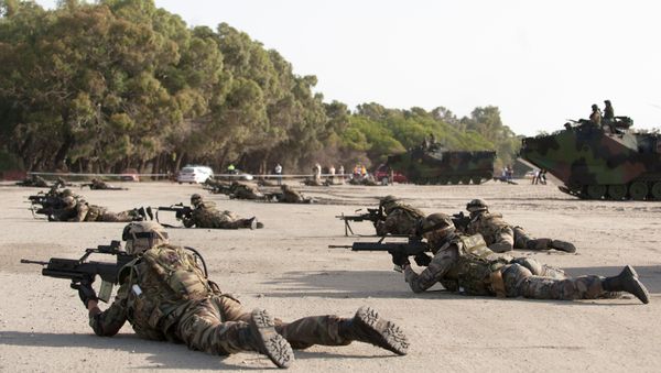 Spanish Navy Marines take position during a military exercise on the Garrucha beach near Almeria, Spain, Tuesday, Oct.21, 2014. NATO warships are exercising in the Mediterranean Sea and Atlantic Ocean as part of a NATO Response Force training to test its crisis response capabilities with over 23 warships - Sputnik International