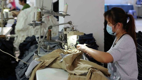 This picture taken on May 12, 2015 shows Chinese workers making jeans at a clothing factory in Shishi, east China's Fujian province. This picture taken on May 12, 2015 shows Chinese workers making jeans at a clothing factory in Shishi, east China's Fujian province. - Sputnik International