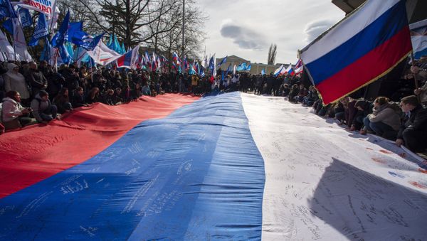 Participants of a rally celebrating the Crimean Spring's first anniversary in front of the Crimean State Council in Simferopol. - Sputnik International