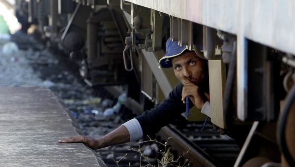 A migrant, hiding under a train, tries to sneak on a train towards Serbia, at the railway station in the southern Macedonian town of Gevgelija, on Monday, Aug. 17, 2015. Over 1,000 migrants from Middle East, Asia and Africa, enter Macedonia daily from Greece, heading north through the Balkans on their way to the more prosperous European Union countries A migrant, hiding under a train, tries to sneak on a train towards Serbia, at the railway station in the southern Macedonian town of Gevgelija, on Monday, Aug. 17, 2015. Over 1,000 migrants from Middle East, Asia and Africa, enter Macedonia daily from Greece, heading north through the Balkans on their way to the more prosperous European Union countries - Sputnik International