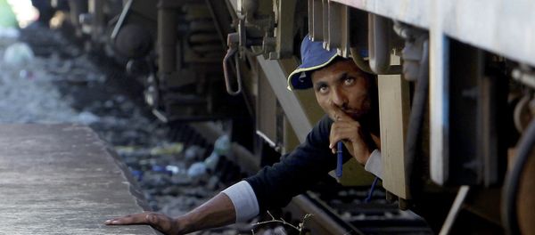 A migrant, hiding under a train, tries to sneak on a train towards Serbia, at the railway station in the southern Macedonian town of Gevgelija, on Monday, Aug. 17, 2015. Over 1,000 migrants from Middle East, Asia and Africa, enter Macedonia daily from Greece, heading north through the Balkans on their way to the more prosperous European Union countries A migrant, hiding under a train, tries to sneak on a train towards Serbia, at the railway station in the southern Macedonian town of Gevgelija, on Monday, Aug. 17, 2015. Over 1,000 migrants from Middle East, Asia and Africa, enter Macedonia daily from Greece, heading north through the Balkans on their way to the more prosperous European Union countries - Sputnik International