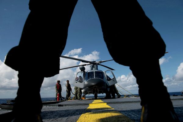 A Philippine Navy personnel stands in front of an AgustaWestland AW109 helicopter aboard the Philippine Navy vessel BRP Ramon Alcaraz. A Philippine Navy personnel stands in front of an AgustaWestland AW109 helicopter aboard the Philippine Navy vessel BRP Ramon Alcaraz. - Sputnik International