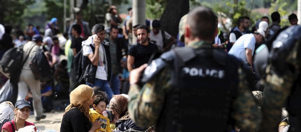 Macedonian special policemen guard the border as more than a thousand immigrants wait at the border line of Macedonia and Greece to enter Macedonia near the Gevgelija railway station August 21, 2015 - Sputnik International