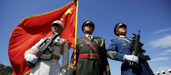 Officers and soldiers of China's People's Liberation Army hold a flag and weapons during a training session for a military parade to mark the 70th anniversary of the end of World War Two, at a military base in Beijing, China, August 22, 2015 Officers and soldiers of China's People's Liberation Army hold a flag and weapons during a training session for a military parade to mark the 70th anniversary of the end of World War Two, at a military base in Beijing, China, August 22, 2015 - Sputnik International
