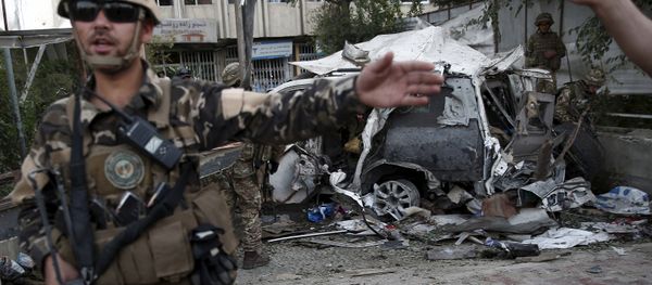 Members of Afghan security forces keep watch in front of a damaged car that belongs to foreigners after a bomb blast in Kabul, Afghanistan August 22, 2015. Members of Afghan security forces keep watch in front of a damaged car that belongs to foreigners after a bomb blast in Kabul, Afghanistan August 22, 2015. - Sputnik International