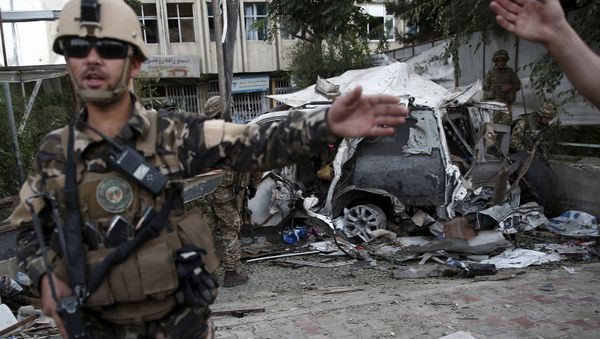 Members of Afghan security forces keep watch in front of a damaged car that belongs to foreigners after a bomb blast in Kabul, Afghanistan August 22, 2015. Members of Afghan security forces keep watch in front of a damaged car that belongs to foreigners after a bomb blast in Kabul, Afghanistan August 22, 2015. - Sputnik International