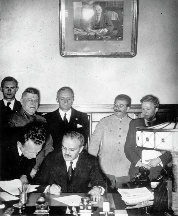 Soviet Commissar for Foreign Affairs Vyacheslav Mikhailovich Molotov, seated, signs the German-Soviet non-aggression pact in Moscow, August 23, 1939, a few days before the outbreak of World War II. - Sputnik International