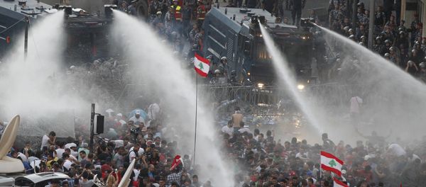 Lebanese protesters are sprayed with water during a protest against corruption and against the government's failure to resolve a crisis over rubbish disposal, near the government palace in Beirut, Lebanon August 23, 2015 - Sputnik International