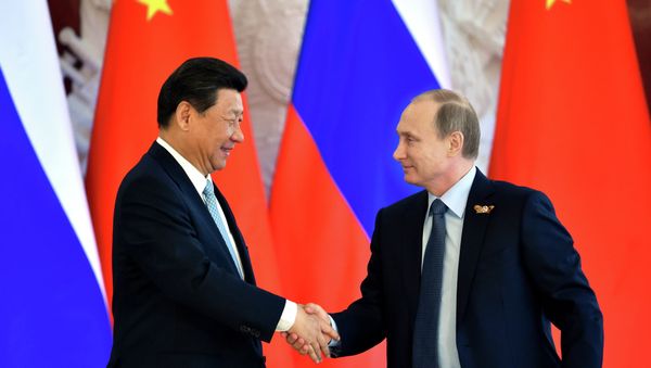 Russian President Vladimir Putin (R) shakes hands with his Chinese counterpart Xi Jinping Russian President Vladimir Putin (R) shakes hands with his Chinese counterpart Xi Jinping - Sputnik International