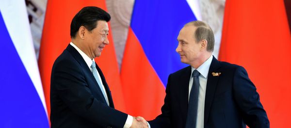 Russian President Vladimir Putin (R) shakes hands with his Chinese counterpart Xi Jinping Russian President Vladimir Putin (R) shakes hands with his Chinese counterpart Xi Jinping - Sputnik International