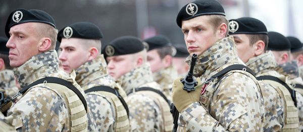 Latvian soldiers stand during a military parade Latvian soldiers stand during a military parade - Sputnik International