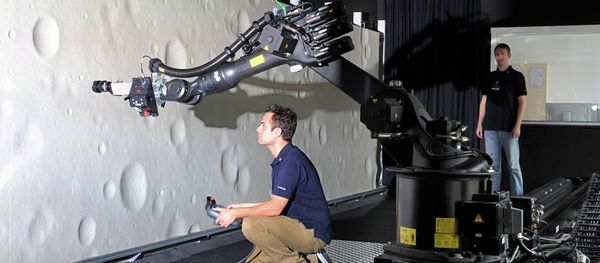 Marco Sagliano (L) and Michael Conradt (R), research assistants at the German Centre for Aerospace (DLR) guide a robotic-optical navigation device for landing on the moon at a test stand in Bremen Marco Sagliano (L) and Michael Conradt (R), research assistants at the German Centre for Aerospace (DLR) guide a robotic-optical navigation device for landing on the moon at a test stand in Bremen - Sputnik International