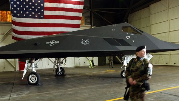 An US Air Force soldier patrol the perimetre around a F-117 Nighthawk stealth fighter jet An US Air Force soldier patrol the perimetre around a F-117 Nighthawk stealth fighter jet - Sputnik International