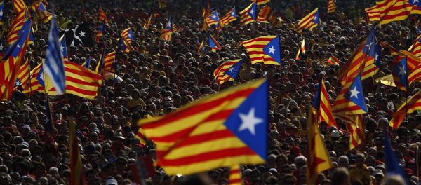 Hundreds of thousands of demonstrators stand on the streets waving their “estelada” flags, that symbolizes Catalonia's independence, during a protest calling for the independence of Catalonia in Barcelona, Spain Hundreds of thousands of demonstrators stand on the streets waving their “estelada” flags, that symbolizes Catalonia's independence, during a protest calling for the independence of Catalonia in Barcelona, Spain - Sputnik International