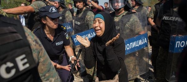 A Syrian refugee cries after she lost her daughter during clashes between Macedonian police and refugees who try to cross the borders in the town of Idomeni, Northern Greece, on Wednesday, Aug. 26, 2015. A Syrian refugee cries after she lost her daughter during clashes between Macedonian police and refugees who try to cross the borders in the town of Idomeni, Northern Greece, on Wednesday, Aug. 26, 2015. - Sputnik International