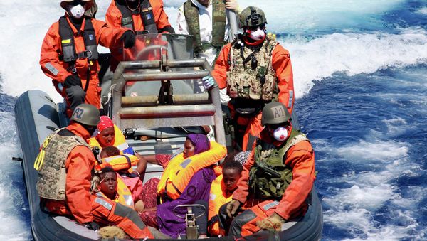 In this Aug. 23, 2015 picture provided by the German Navy pregnant Somali refugee, Rahma Abukar Ali center, sits in a boat of the German Navy in the Mediterranean Sea, near Italy In this Aug. 23, 2015 picture provided by the German Navy pregnant Somali refugee, Rahma Abukar Ali center, sits in a boat of the German Navy in the Mediterranean Sea, near Italy - Sputnik International