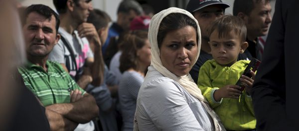 Migrants wait for the visit of German President Joachim Gauck in an asylum seekers accommodation facility in Berlin, Germany, August 26, 2015 Migrants wait for the visit of German President Joachim Gauck in an asylum seekers accommodation facility in Berlin, Germany, August 26, 2015 - Sputnik International