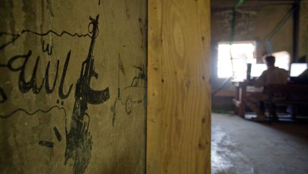 Taliban graffiti shows an AK-47 assault rifle and the word 'Allah' at left, translated from Pashto, decorating a wall in the Musa Qala district center. - Sputnik International
