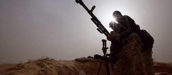 Libyan soldiers try to fix a weapon that jammed during clashes with militants on the frontline in Al Ajaylat, 120 kilometers (75 miles) west of Tripoli, Libya - Sputnik International