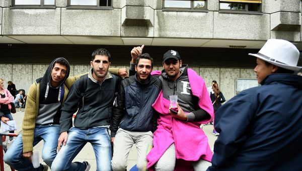 Syrian refugees queue outside outside the State Office of Health and Social Affairs in Berlin (LAGeSo) where hundreds of migrants wait to receive help from the Berlin administration on August 25, 2015 Syrian refugees queue outside outside the State Office of Health and Social Affairs in Berlin (LAGeSo) where hundreds of migrants wait to receive help from the Berlin administration on August 25, 2015 - Sputnik International